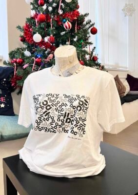 A Hype dance branded tee hoodie in front of a Christmas tree